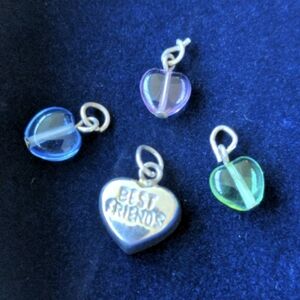 Four 925 sterling silver heart shaped bracelet charms